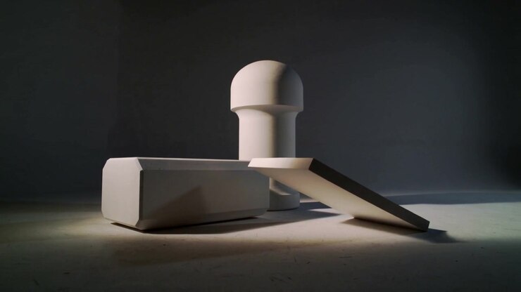 Sliding panel losing balance, pivoting on table to rest flat in front of block and cylinder