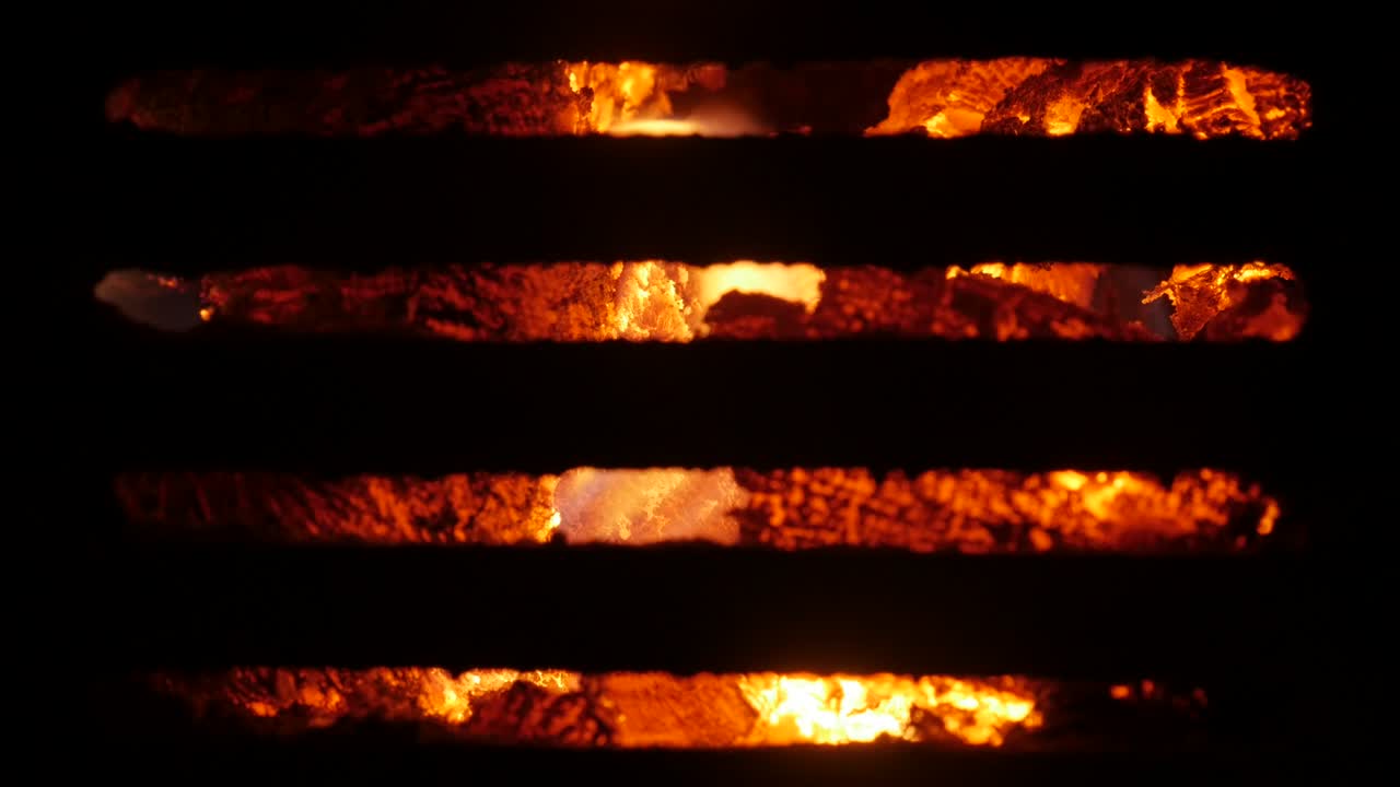 Steel grate in front of stove burning fire close-up