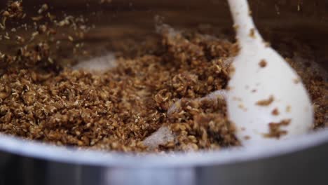 Close-up-shot-of-stirring-malted-barley-in-the-beer-making-process