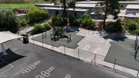 Aerial-View-of-Ralph-Dailard-Elementary-School-Playground-Yard,-San-Carlos-Community-San-Diego-California,-Games-Sports-Concrete-Schoolyard-Ground-Surrounded-by-Residential-Neighborhood-Area-and-Hill