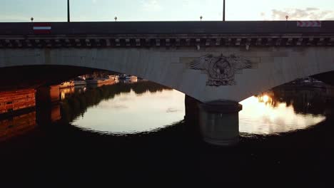 aerial moving along and facing the iéna bridge, at sunrise, over seine river. close