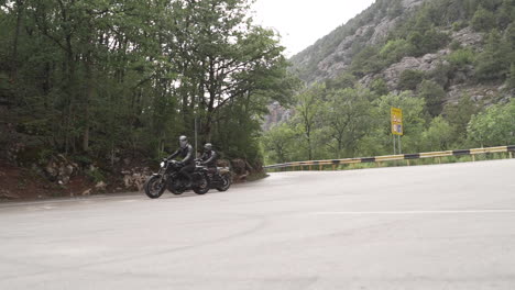 two motorcyclists on a scenic mountain road