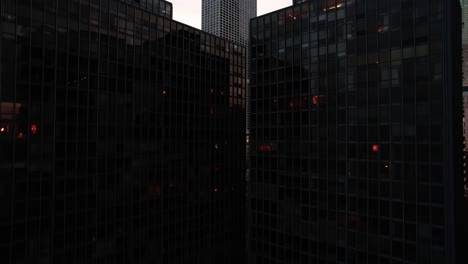 revealing chicago behind two tall black buildings
