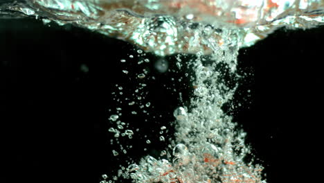 vine tomatoes falling in water