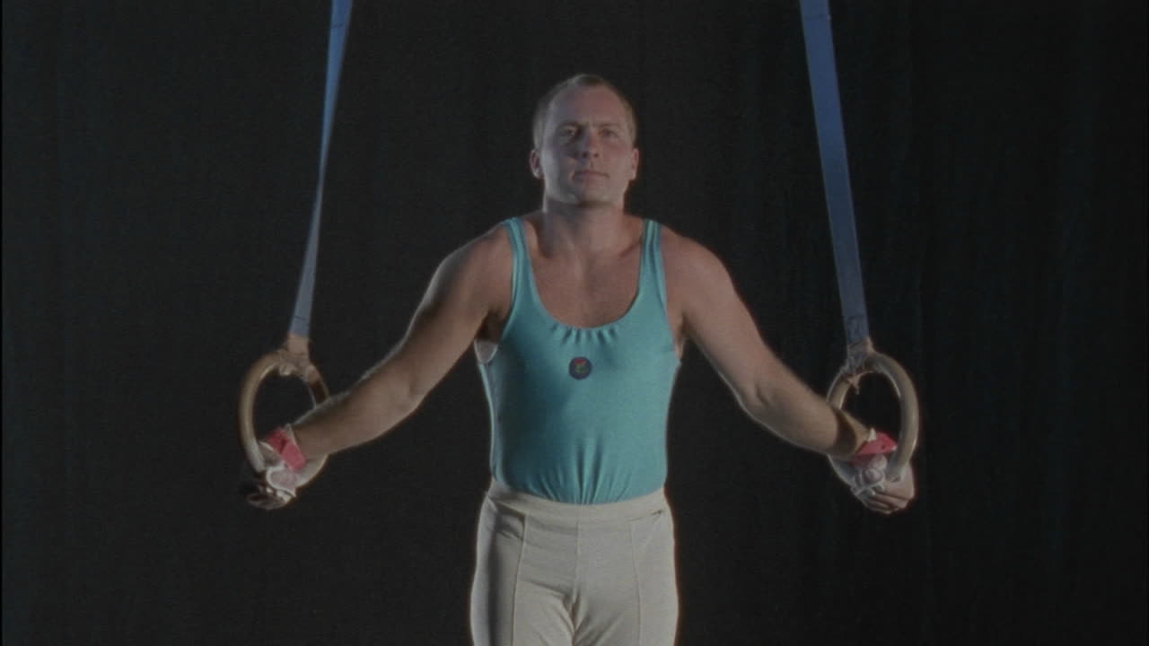 A gymnast dismounts after performing a routine