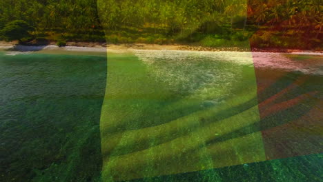 digital composition of waving belgium flag against aerial view of waves in the sea