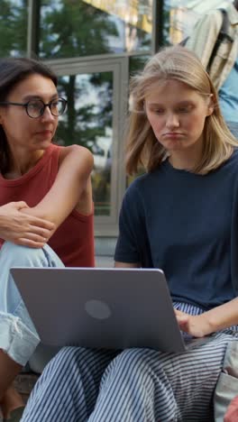 friends collaborating on a laptop outdoors