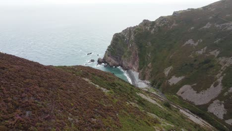 Aerial-View-Over-Rocky-Beach-with-Coastal-Cliffs