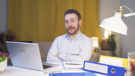 Home-office-worker-man-smiles-at-camera.