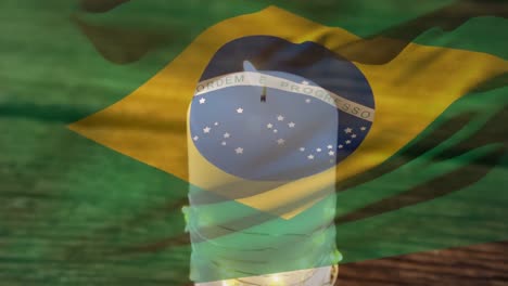 animation of flag of brazil over candle