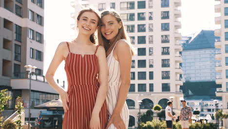 two women friends posing in city