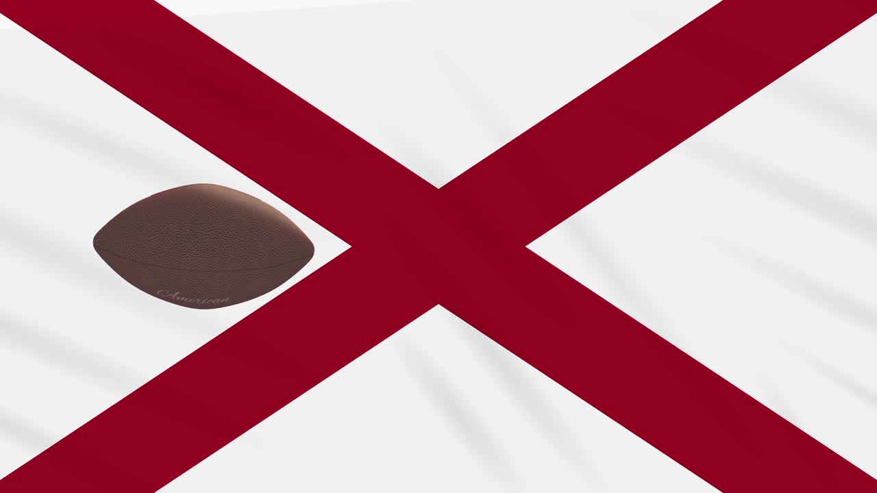 la bandera de alabama agita y la pelota de fútbol americano gira, en bucle