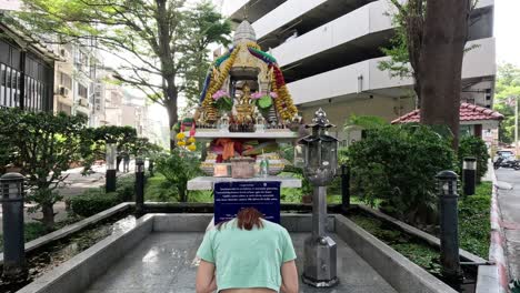 person walking towards an ornate shrine