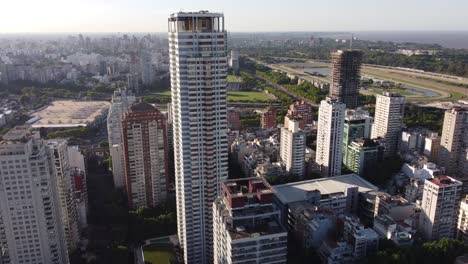 Aerial-flight-towards-Skyscraper-building-in-Buenos-Aires-City-at-sunset-time