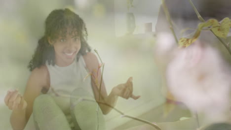 animation of plants and flower over two happy diverse teenage girls talking at home
