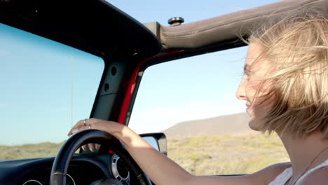 young caucasian woman enjoys a drive in a convertible on a road trip, with copy space