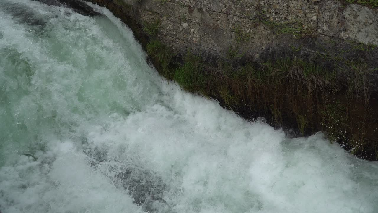 River dam - Flowing and splashing water in cold river.