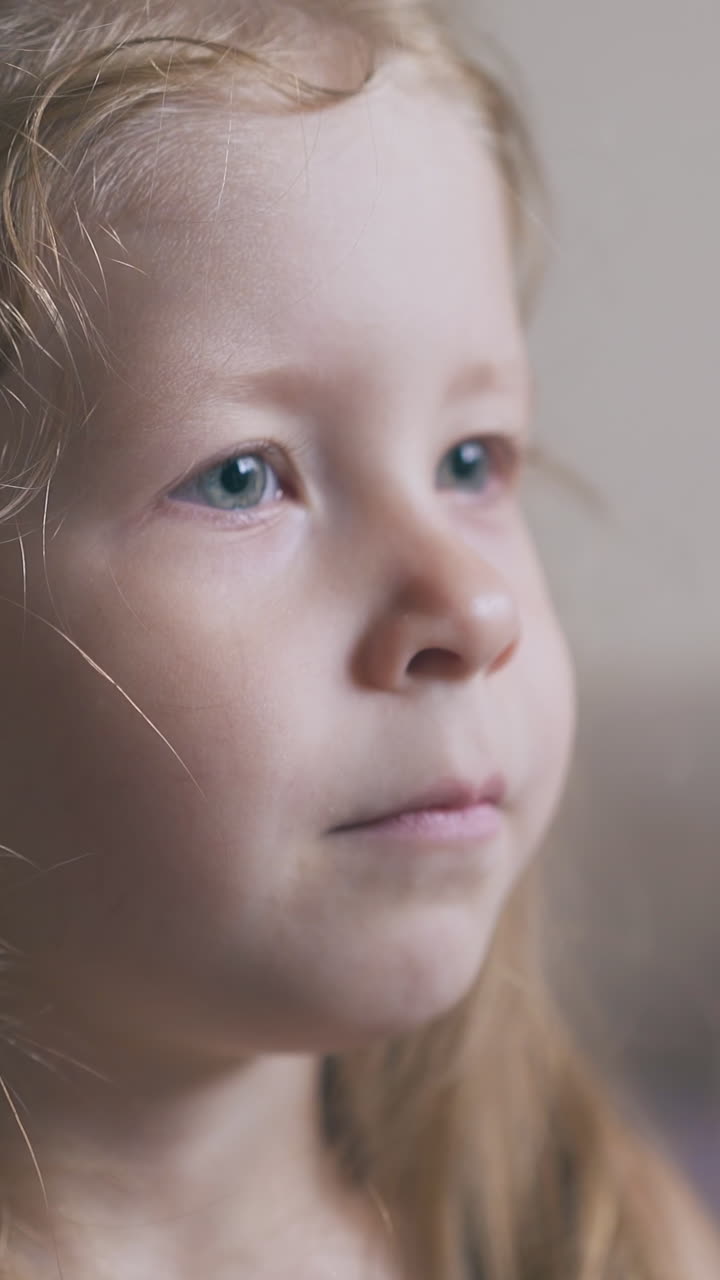 mommy sprays sore throat of ill little girl to cure disease in light room on blurred background extreme close view