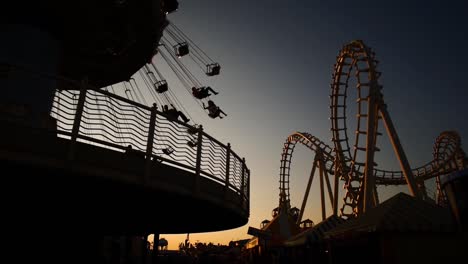 carnival rides during sunset on boardwalk