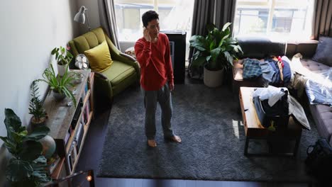 man talking on mobile phone in living room 4k