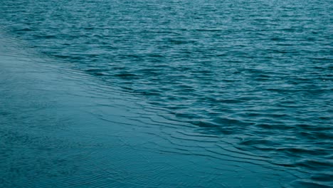 the calm waves of blue ocean in slow motion - wide shot