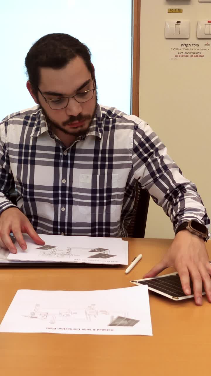 Architect Opening a Folder with Solar Connection Plans