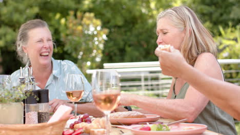 senior caucasian women enjoy a meal outdoors