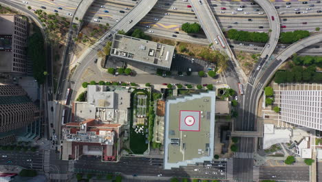 Aerial-birds-eye-view-over-high-rise-and-the-CA-110-in-sunny-Los-Angeles,-USA