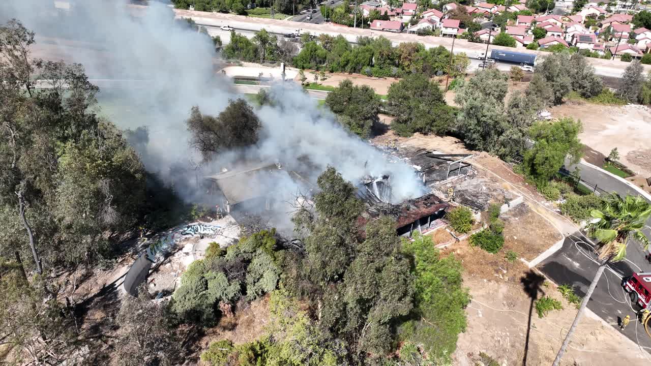 Firefighters Battle Burning House Fire Aerial View