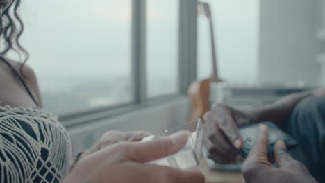 young couple sharing cassette tapes, smiling and chatting