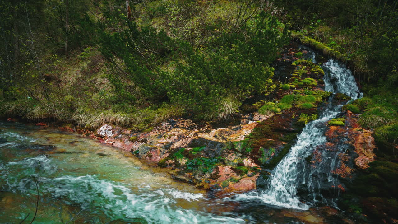 Cinemagraph seamless video loop of a scenic and idyllic mountain river waterfall canyon with fresh blue water in the Bavarian Austrian alps, flowing down a green nature spring for kayaking in 4K UHD