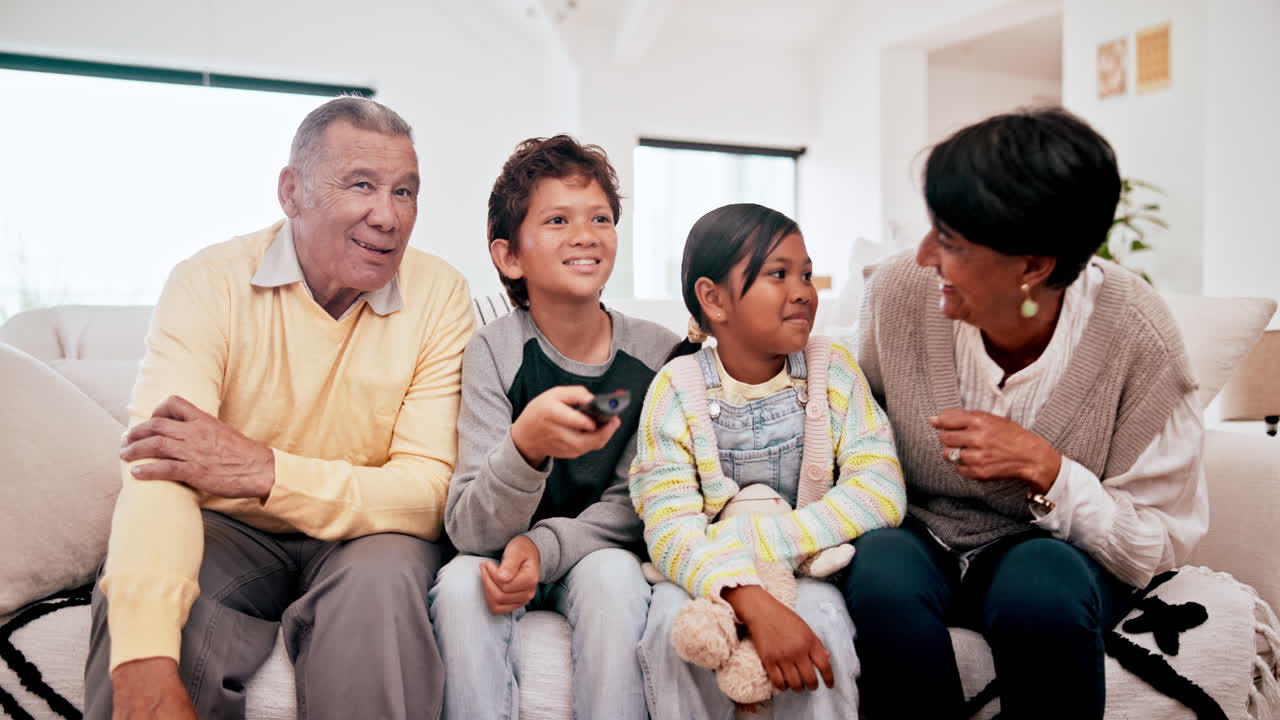 Family, grandparents and children watching tv
