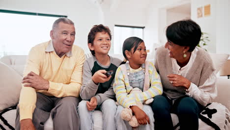 family, grandparents and children watching tv