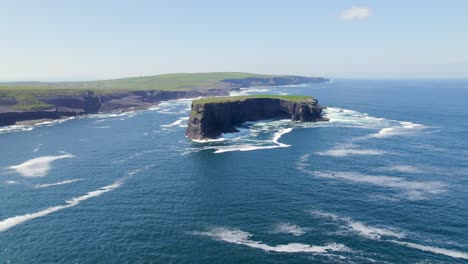 aerial approach towards illaunonearaun islet with kilkee cliffs in the background