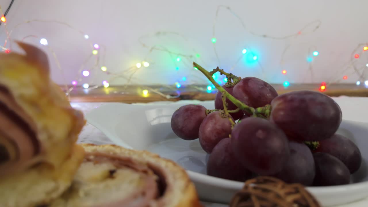 Soft focus shot of grapes with colorful Christmas lights in the background