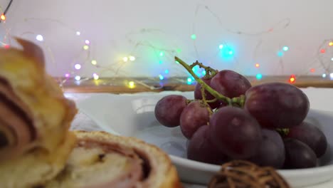 soft focus shot of grapes with colorful christmas lights in the background