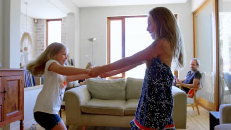 Siblings-dancing-together-in-living-room-4k