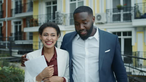 Pareja-De-Negocios-Sonriente-Abrazándose-En-La-Calle-Urbana.-Hombre-Y-Mujer-Caminando-Al-Aire-Libre