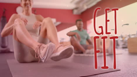 animation of get fit text over diverse man and woman exercising in gym