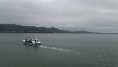 Drone-shot-of-a-fishing-boat-setting-sail