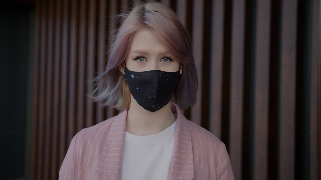 Young woman wearing a mask in a stylish outfit