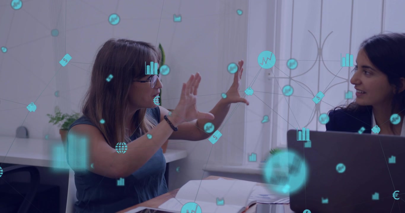 Vertical video: Pair at desk, left woman speaking, gesturing and animating teal icons for business