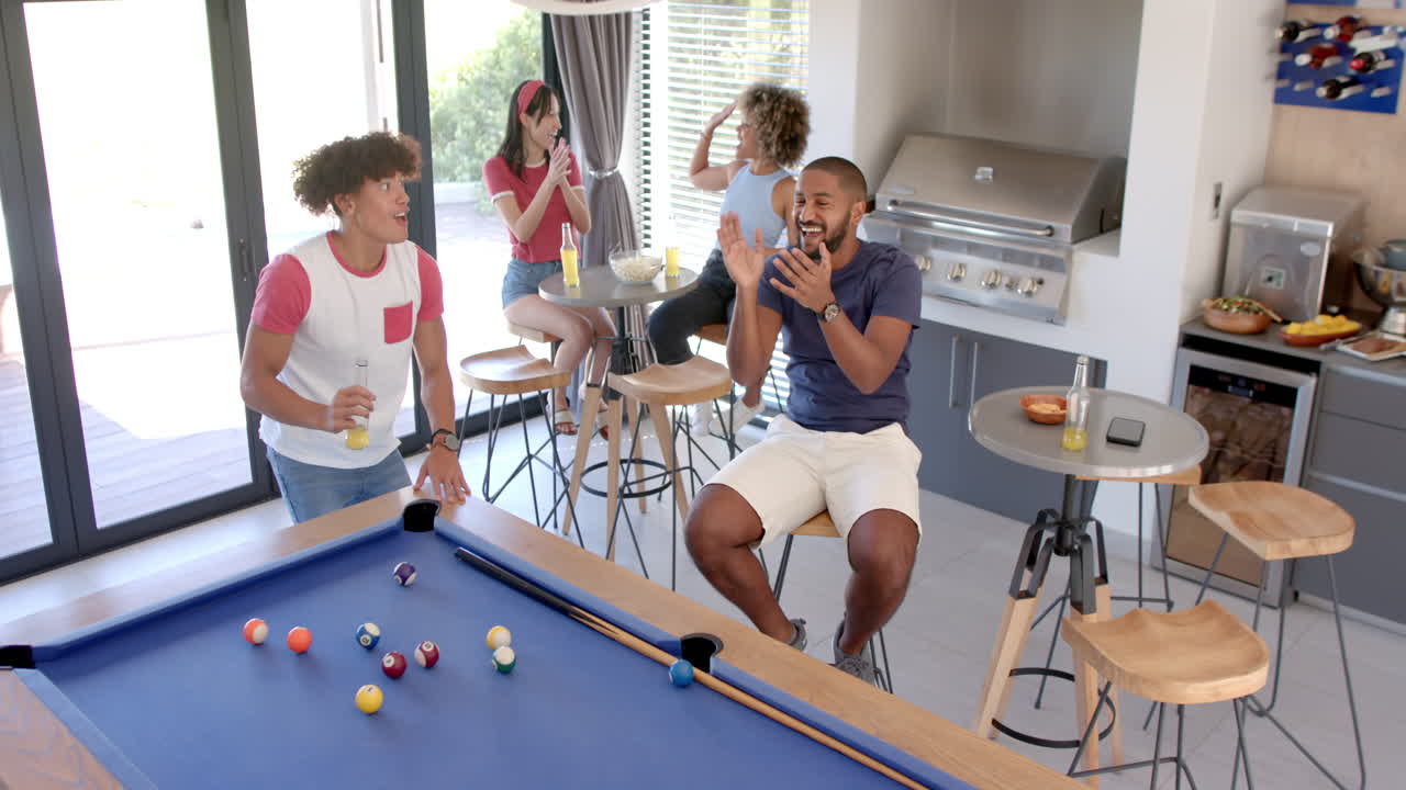 Playing pool and socializing, Diverse friends enjoying fun hangout at home