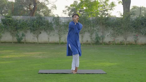 Indian-man-doing-Eagle-yoga-pose