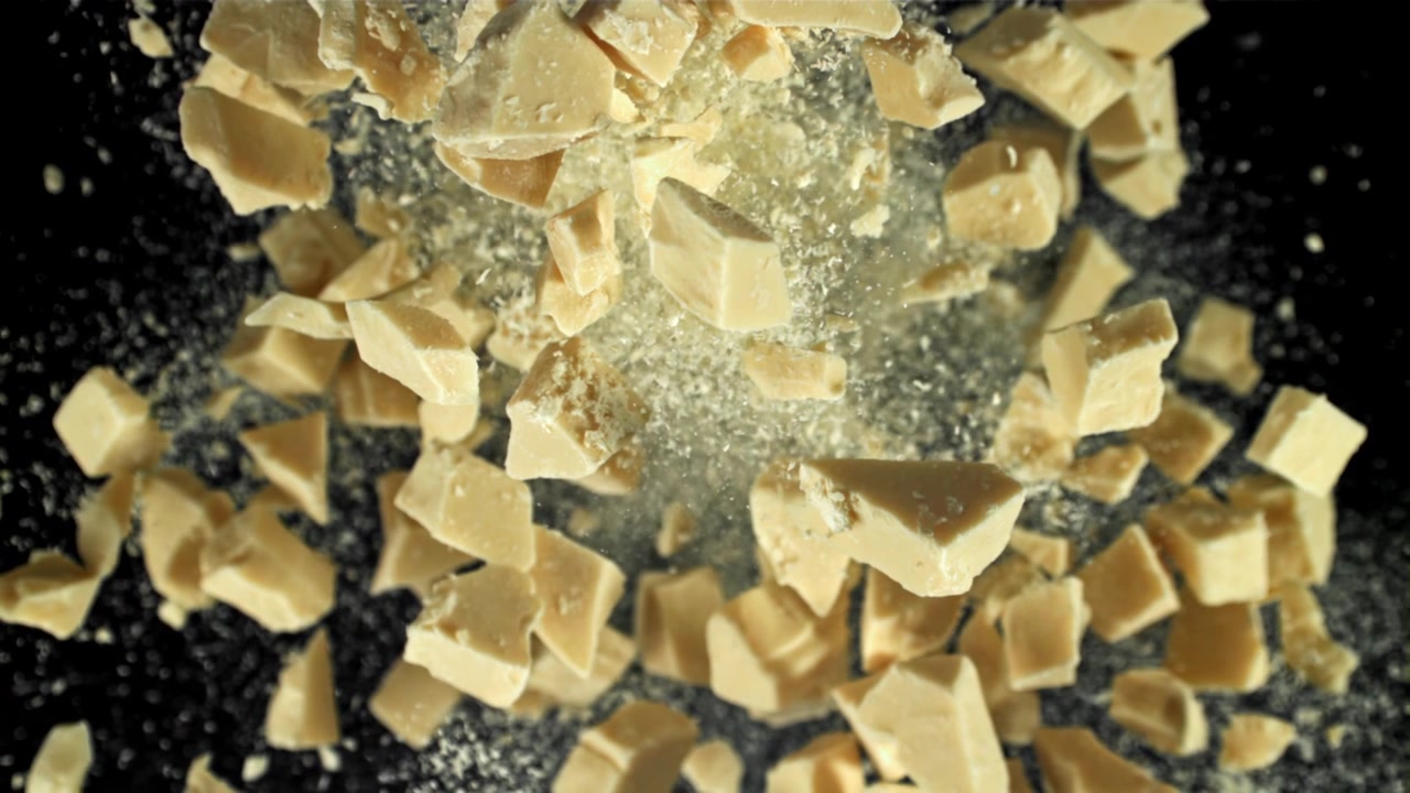 White Chocolate Chunks and Powder Exploding in Slow Motion