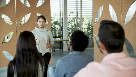 Focused-young-woman-responding-to-questions