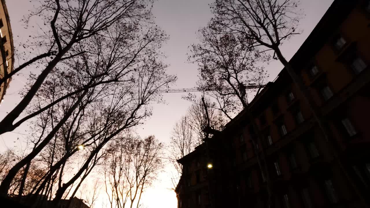 Sunset Drive in Italy: Urban Landscape with Crane and Trees