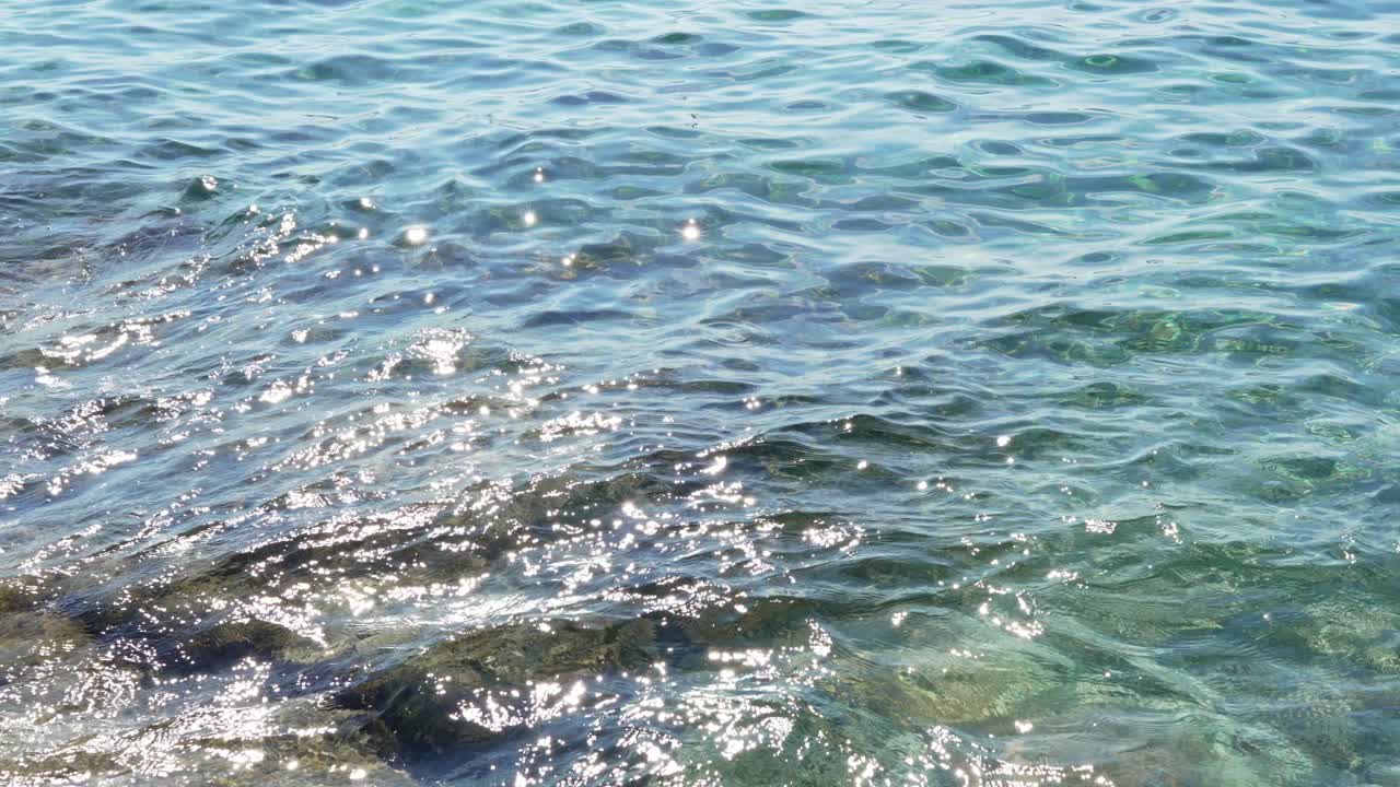 Sprankelende zonlichtreflecties op helderblauw oceaanwater