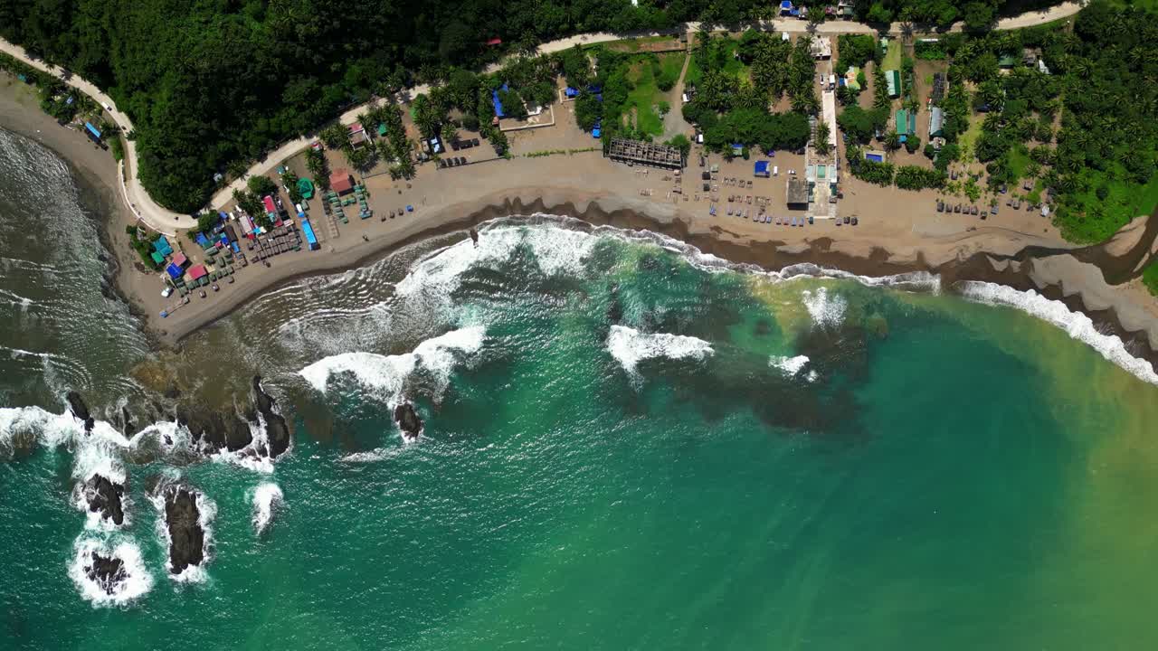 Top view aerial pan of the Matawe Rock Formations in Dingalan, Aurora, showcasing rugged coastal rocks, turquoise waters, and waves breaking dramatically along the shoreline