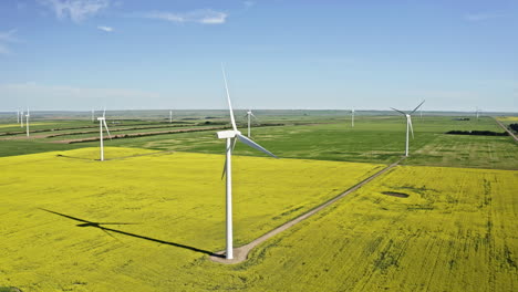 right to left aerial panning shot of wind turbines